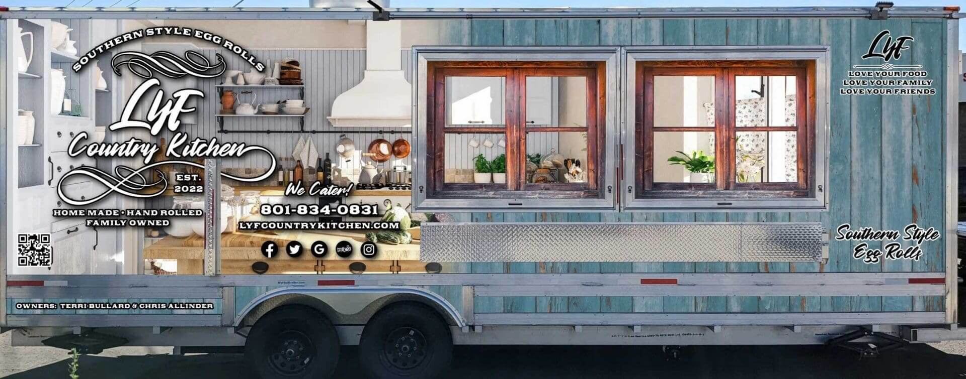 A rustic food truck with wooden window frames and vintage decor.
